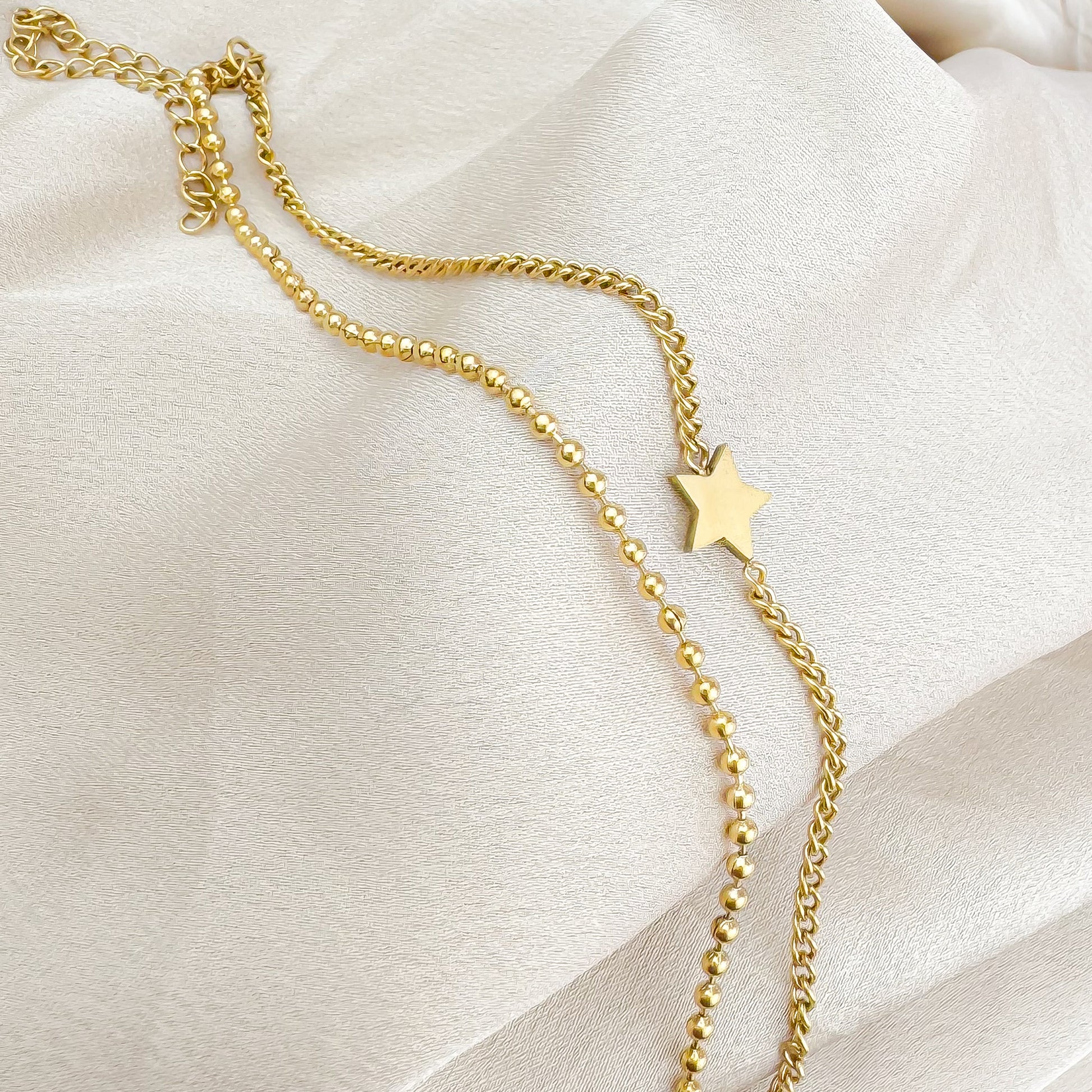 Arden gold double chain bracelet with star